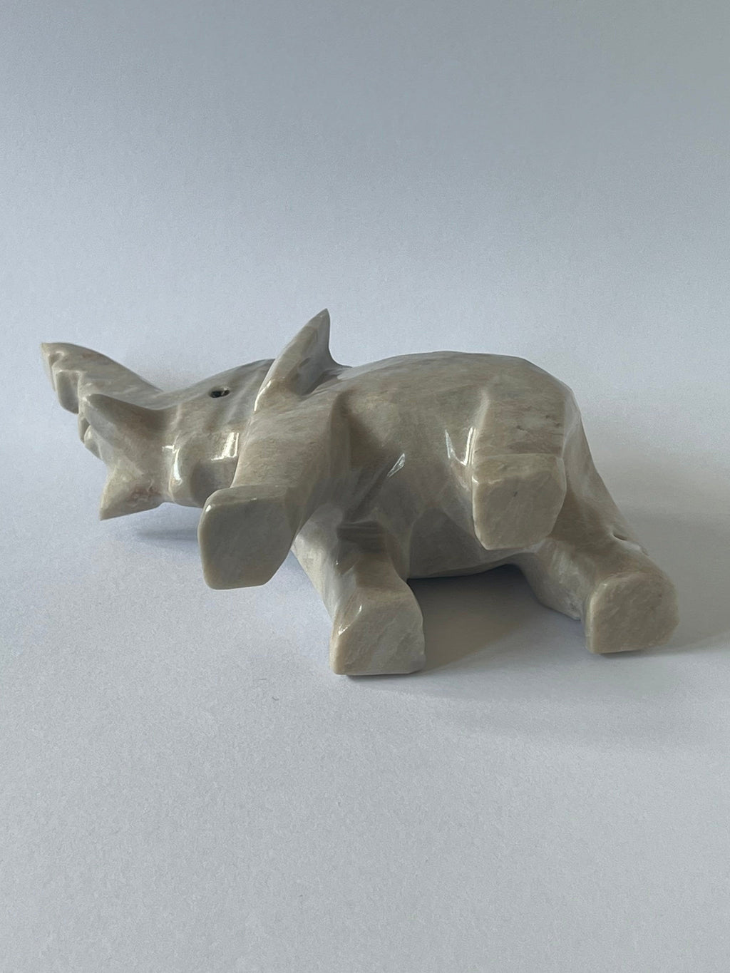 Gray Elephant Sculpture laying on it's side