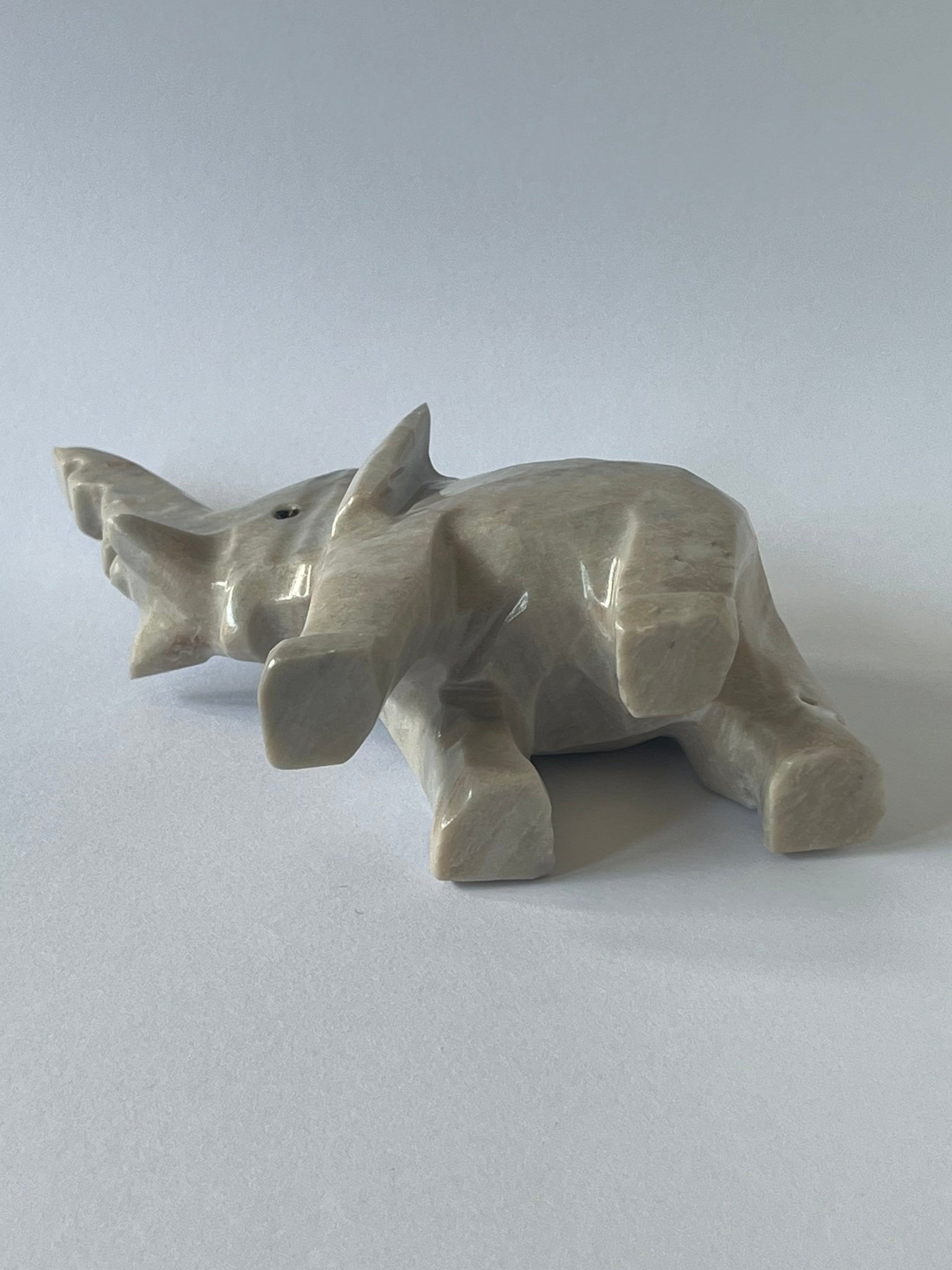 Gray Elephant Sculpture laying on it's side