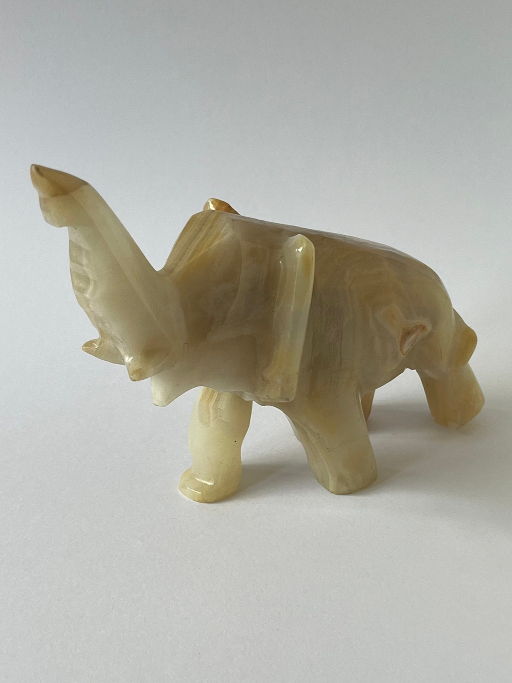Beige Onyx Elephant Sculpture against a white background